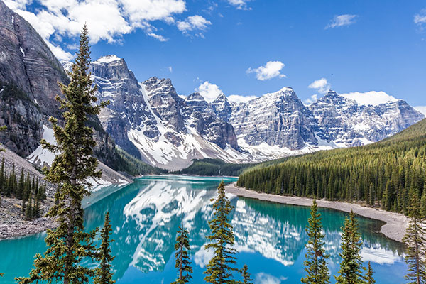 Majestic mountains in the background. Clear turquoise blue water.